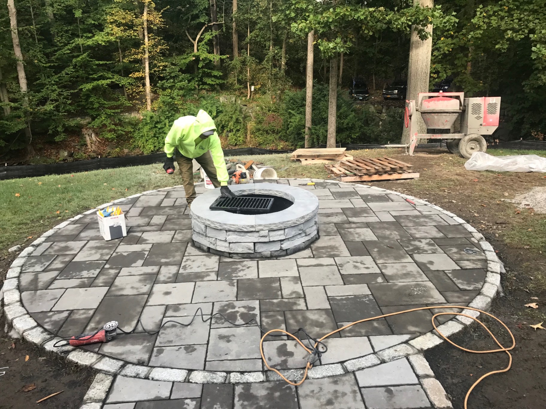 Circular paver patio with a stone fire pit